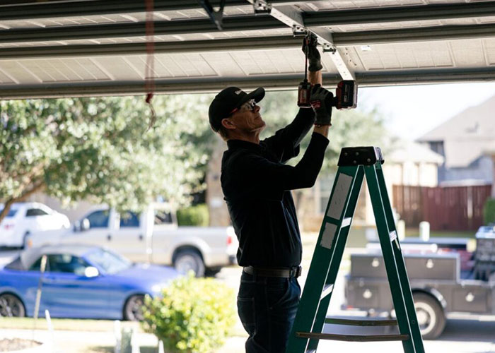 Technician working on garage door motor